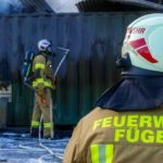 Wirtschaftsgebäude in Vollbrand wird von Feuerwehrleuten gelöscht